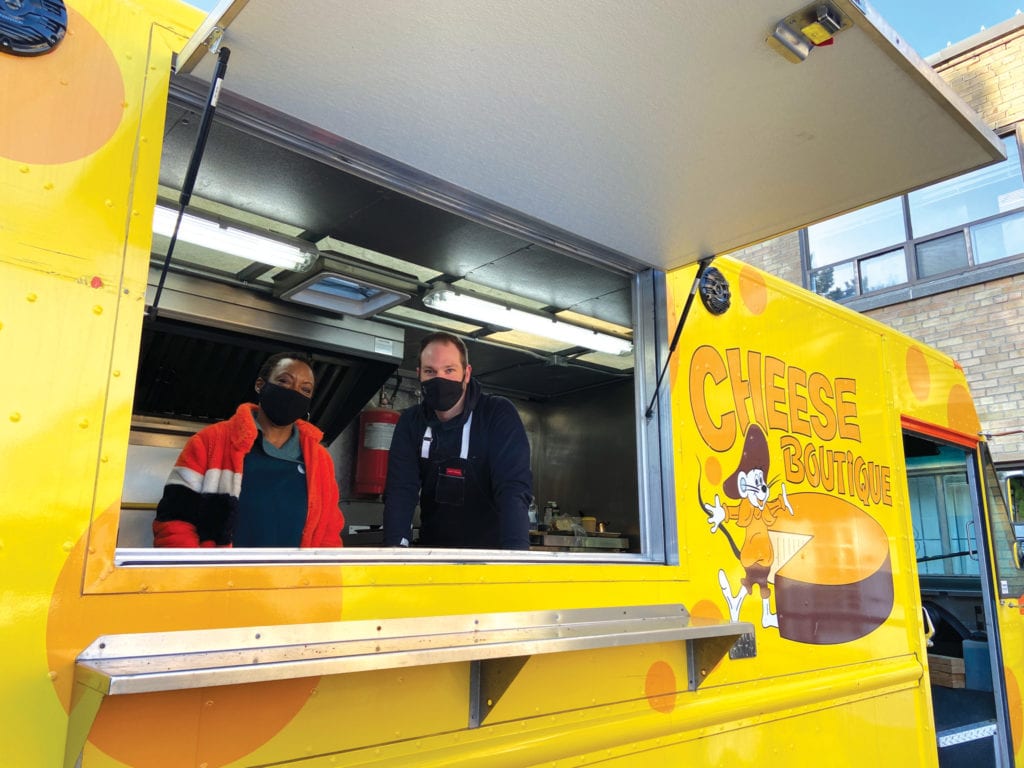 Guest chefs Opal Rowe and Romain Avril looking out from a food truck