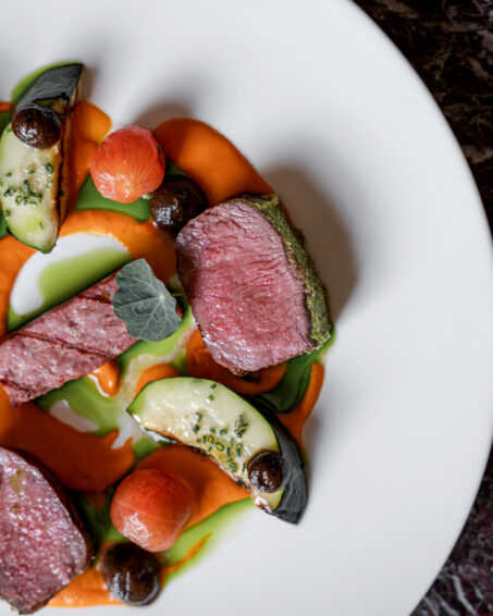 Lamb saddle, red pepper purée, black garlic, eggplant, seasonal vegetables.